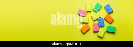 plenty of multicolored washcloths on yellow background, top view, banner Stock Photo