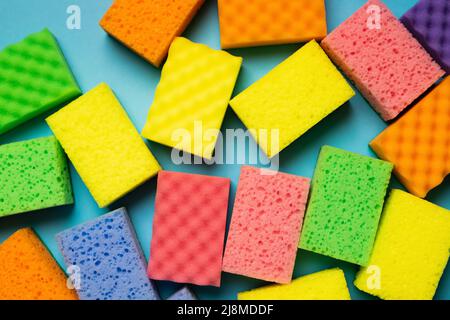 plenty of multicolored washcloths on blue background, top view Stock Photo