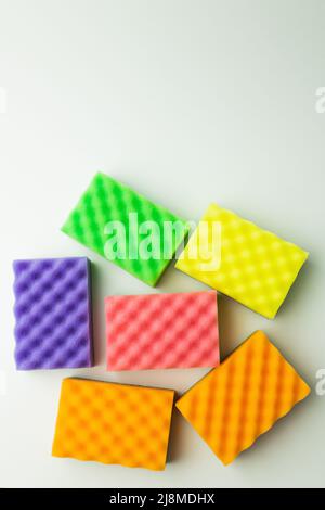 top view of bright multicolored sponges on grey background Stock Photo