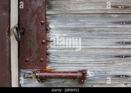 Old medieval rusted iron lock on the front door of a building in Lithuania Stock Photo