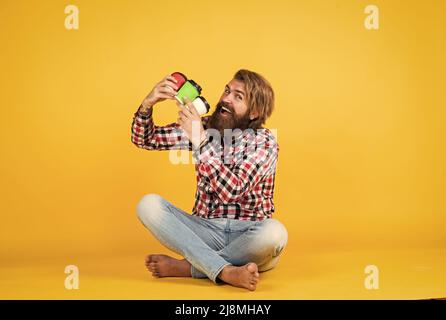 making mix. hipster man drink coffee. handsome bearded man holding a white cup. mug with beverage. drinking tea or coffee. good morning. morning vibes Stock Photo
