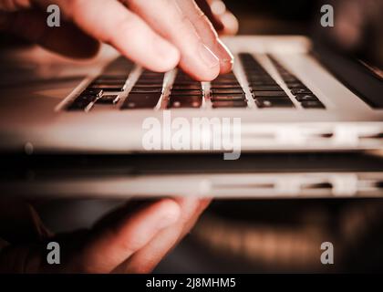Office Worker Using Laptop Computer on a Glassy Desk. Remote Working Concept. Stock Photo
