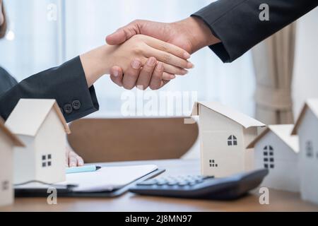 Cropped Image Of People Shaking Hands Over Desk. Stock Photo