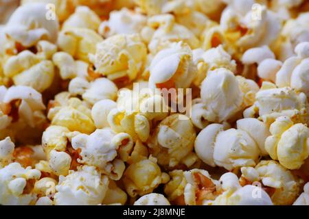 popcorn spilling from a container on red background  Stock Photo