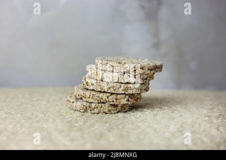 Rice buckwheat cake on a background of strewn rice groats Stock Photo