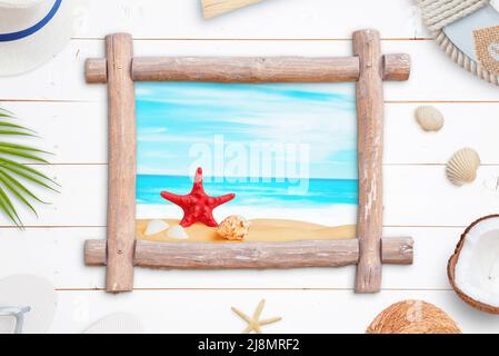 Tropical beach window like wooden frame surrounded by summer vacation accessories Stock Photo