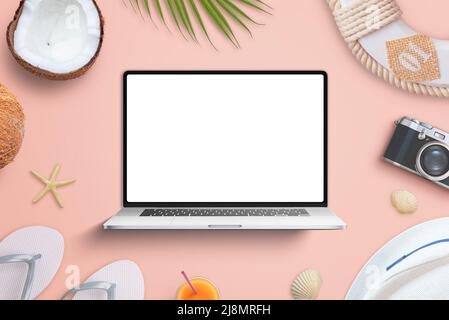 Laptop mockup laid on the beach, surrounded by coconuts, camera, hat, slippers. Top view, flat lay composition Stock Photo