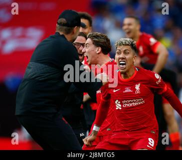 LONDON, ENGLAND - MAY 14:Liverpool's Roberto Firmino celebrates after Liverpool's Kostas Tsimikas scoring the goal in the penalty shoot out during FA Stock Photo