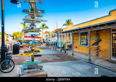 Key West distance marker and colorful street view, Florida Keys, United States of America Stock Photo