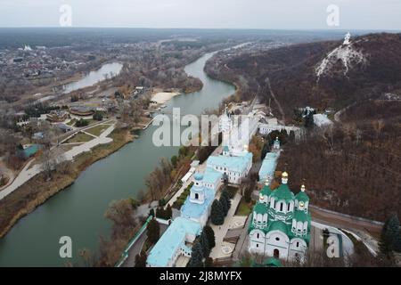 Panoramic aerial drone view of Svyatohirsk Lavra, Seversky Donets river with bridge, and village of Svyatohirsk, Donetsk region, Ukraine. Stock Photo