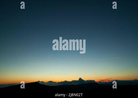 Vivid colours of a winter sunset, with low cumulus clouds on the horizon. Cyprus Stock Photo