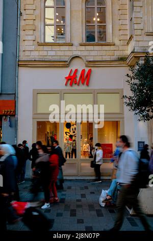 H and M street store and motion blur of the people in Istiklal Avenue or Istiklal Caddesi. vertical photo. Istanbul Turkey - 11.13.2021 Stock Photo
