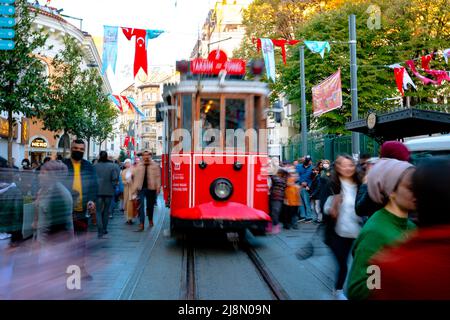 Nostalgic Tram in Istiklal Avenue. Motion blur on the tram and people. Istanbul Turkey - 11.13.2021 Stock Photo