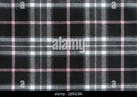Checkered fabric texture - black, gray, white and pink colors. Macro. Closeup.. Stock Photo