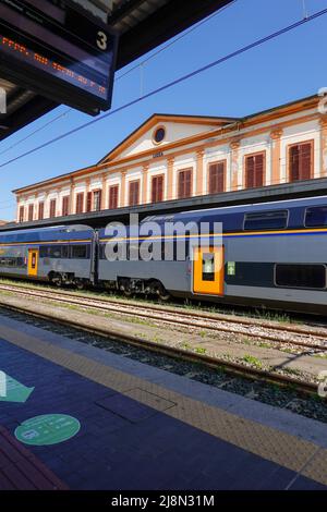 Local or regional train on train tracks outside the Lucca Tuscany