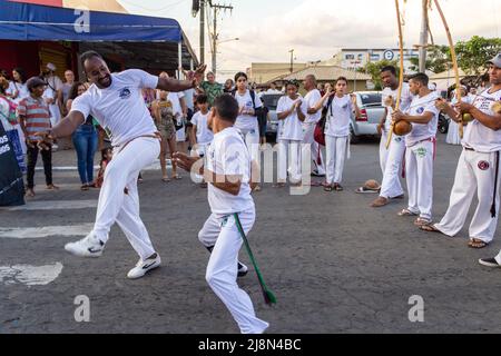 Aparecida de Goiania, Goiás, Brazil – May 15, 2022: A group of people demonstrating the capoeira fight in the Procession of Pretos Velhos. Stock Photo