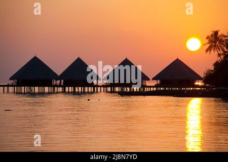 Sunset behind the over-water bungalows, Rannalhi, Maldives South-Male Atoll, Indian Ocean, Asia Stock Photo
