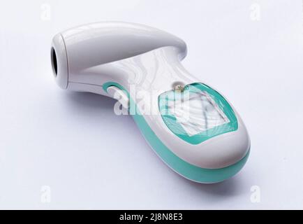 Non-contact infrared forehead digital thermometer. Isolated on white. Stock Photo