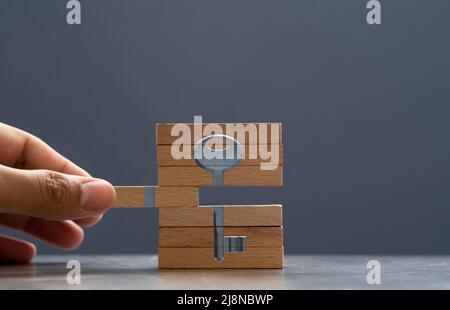 Hand putting wooden blocks together. Concept of finding solution. Stock Photo