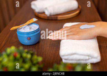 Putting Tatcha cream for hands Stock Photo
