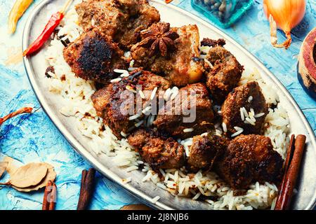 Spicy vindaloo meat with rice. Pork cooked in spicy garlic sauce Stock Photo