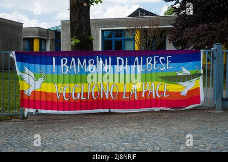 Lombardia, Italy - 05.01.2022: Rainbow flag with Italian text 'The Albese children want peace' (I bambini di Albese vogliono pace) Stock Photo