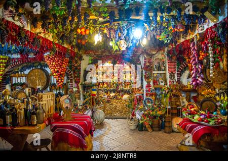 20 September 2019 Shop with autumn products in Romania in Brasov.Brightly coloured vegetables and fruits from the autumn harvest and barrel wine Stock Photo