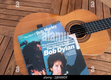 Bob Dylan and Bob Marley guitar chord songbooks on guitar Stock Photo