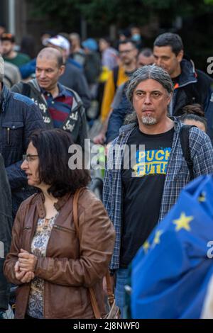Sofia, Bulgaria - May 09, 2022: A middle age grey hair man with a beard, wearing t-shirt Puck Futin walks in a crowd Stock Photo