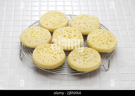 freshly baked crumpets cool on a cake cooler Stock Photo