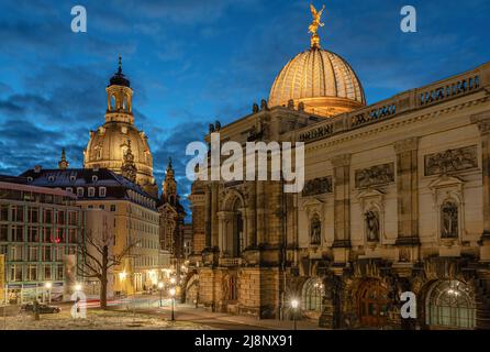 Illuminated art gallery in the Lipsius Building on Georg-Treu-Platz with the Frauenkirche Dresden at night, Saxony, Germany Stock Photo