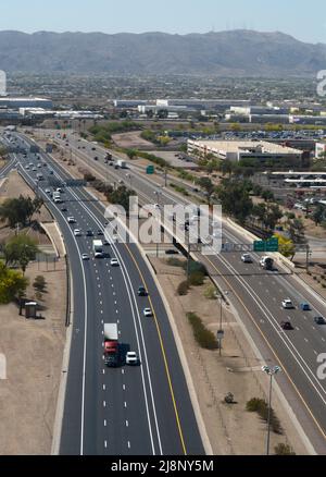 View from the window of a passenger airplane as it flies over Interstate 10 on its approach to Phoenix Sky Harbor International Airport in Arizona. Stock Photo