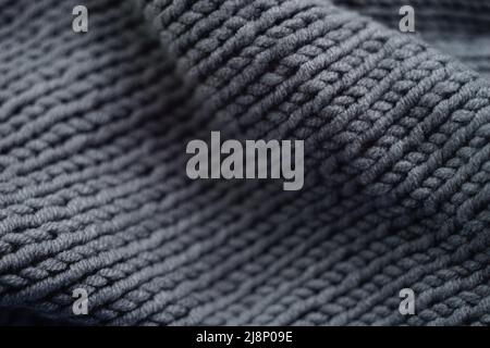 Knitted grey background, gray scarf cozy pattern. Stock Photo