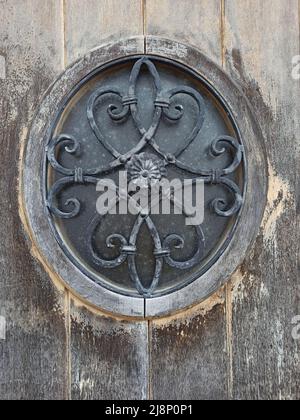 Wrought iron oval lattice on the front door window from the island of Terceira Stock Photo
