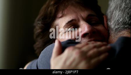 Senior wife hugging husband close-up face. Married older couple showing empathy and support Stock Photo