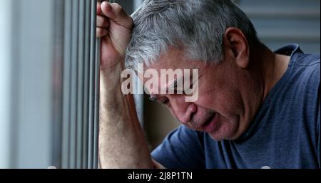Troubled older man crying. Sad depressed senior person cries Stock Photo