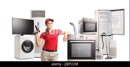 Repairwoman with a drill and home electrical appliances isolated on white background Stock Photo