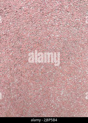 Textured red background, rubber coating for stadiums, running tracks, tennis courts. Top view, close-up Stock Photo