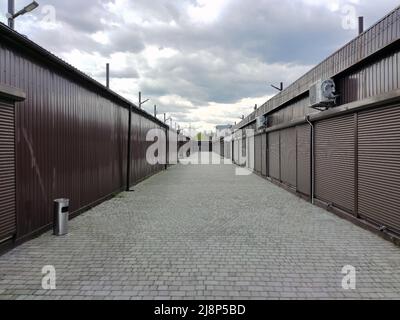 Rows of closed shutters of security shops and kiosks in the future. Without people Stock Photo