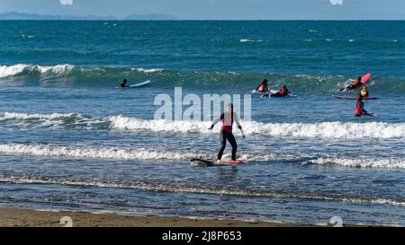 Sumner, Christchurch, Canterbury/New Zealand - March 18, 2022: Surfers in surf school at Scarborough Beach, Sumner, Christchurch, Canterbury. Stock Photo