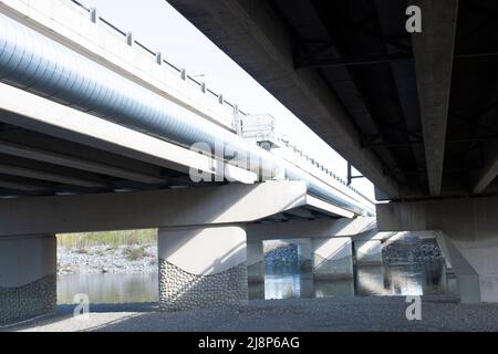 Low Angle View Below Overpass Bridge - Cement Structure Stock Photo