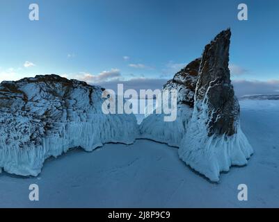 Aerial view of a frozen landscape at sunset with vibrant orange and red ...