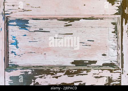 Old weathered wood door panel with peeling paint background Stock Photo