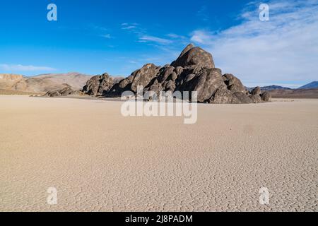 Rock island on the dry lake bed of the Racetrack Playa in Death Valley National Park Stock Photo