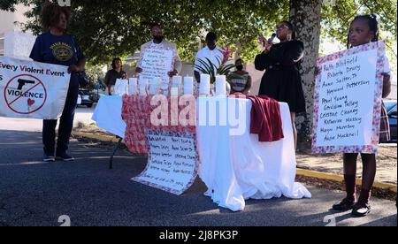 May 17, 2022, Decatur, Georgia, USA: A young mourner holds a sign bearing the names of the ten victims of a mass shooting that occurred in Buffalo, NY; the group of mourners gathered in the parking lot of a Big Bear grocery store in Decatur, GA to hold a memorial for the ten victims of a racist mass shooter in Buffalo, New York. The victims, all black, were murdered by an 18 year-old white male who traveled to a grocery in Buffalo, and according to a manifesto he had written that was filled with white supremacist ideologies, wanted to attack black people specifically. (Credit Image: © John Ar Stock Photo