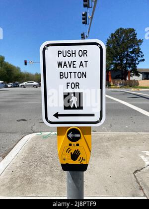 Pedestrian crosswalk, Push or Wave At Button, installed at traffic lights with a dedicated pedestrian signal Stock Photo