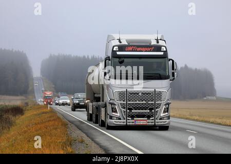 Silver Volvo FH truck and tank trailer of UM Transport Ab in highway 2 traffic on a foggy day of autumn. Humppila, Finland. October 20, 2020. Stock Photo