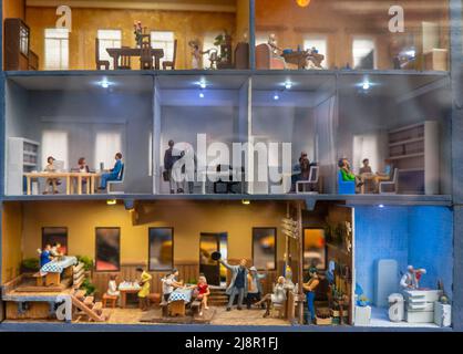 Saint Petersburg, Russia - December 9, 2019: Miniature building cut in halves. See through half interior with people figures inside a house on the exh Stock Photo