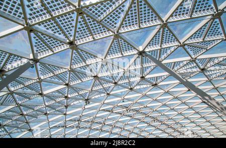 Abstract high-tech architecture background photo, internal structure of glass roof arch with lockable windows sections. Transparent glass roof of a mo Stock Photo