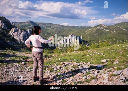 Senior woman taking photos in Velebit mountain, Croatia Stock Photo